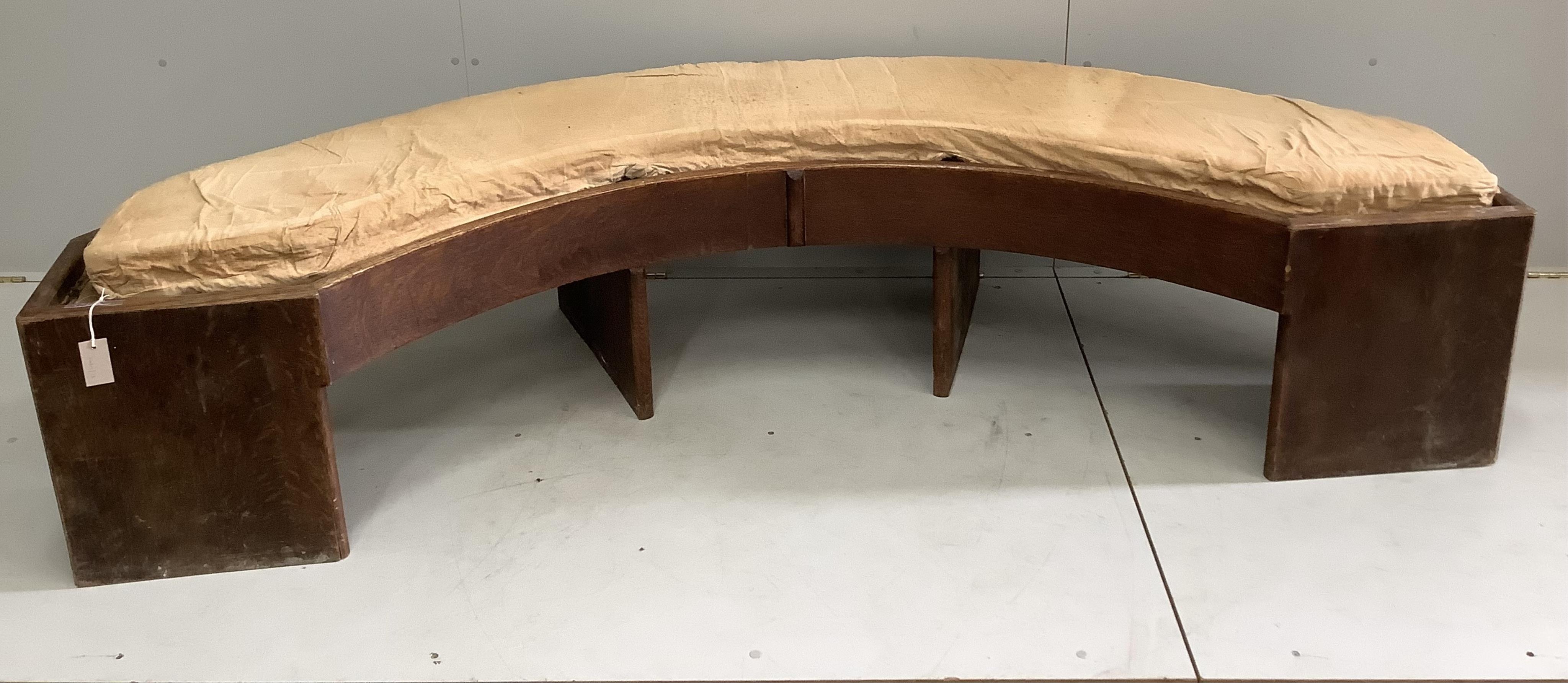A Provincial oak curved bench seat, width 221cm, depth 80cm, height 45cm